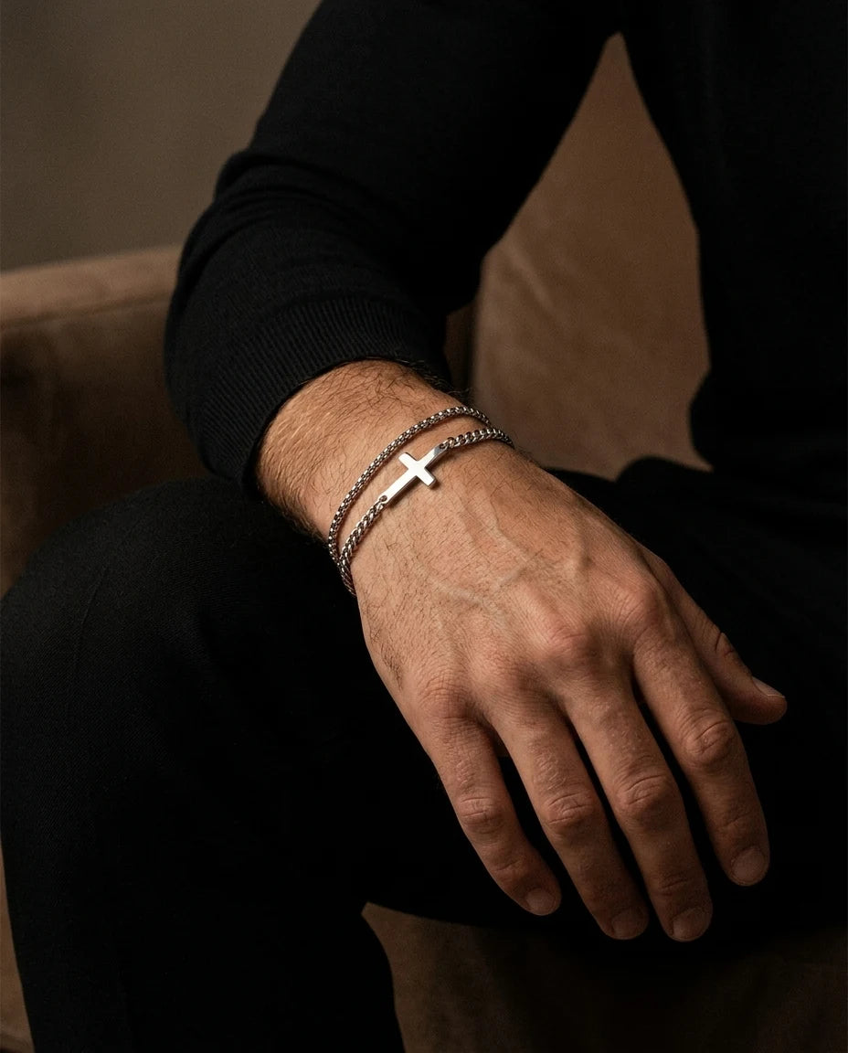 Silver Stellan bracelet stacked with a second chain on a wrist, black sweater