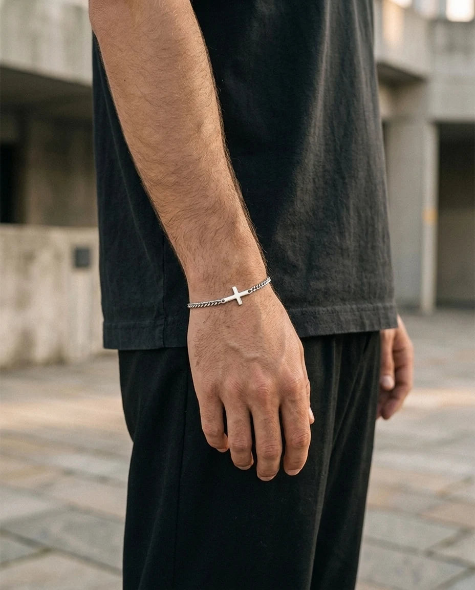 Silver Stellan sideways-cross bracelet worn with a black tee, outdoors